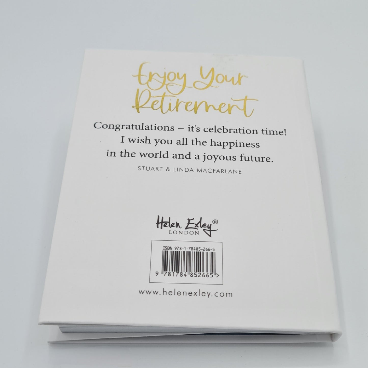 Back cover of little white book with the title "Enjoy your Retirement" written in gold font at the top of the book. Half way down the page, there is a quotation from Stuart & Linda MacFarlane "Congratulations - it's celebration time! I wish you all the happiness in the world and a joyous future" written in black text.