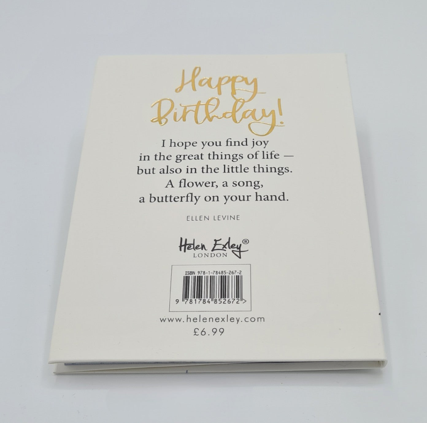 White back cover of the book entitled "Happy Birthday" with the title written in gold font. The page also features the quotation "I hope you find joy in the great things of life - but also in the little things. A flower, a song, a butterfly on your hand" from Ellen Levine.