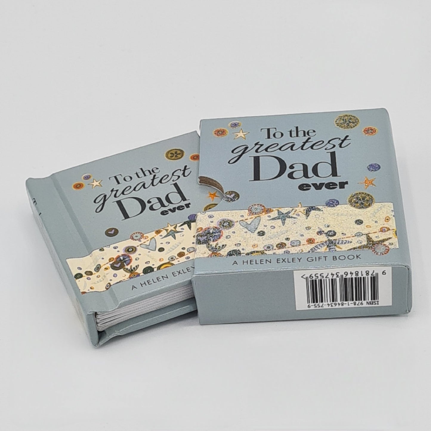 Small light blue book entitled "To the greatest dad ever" with a sleeve. The image shows the book half way out of the sleeve.