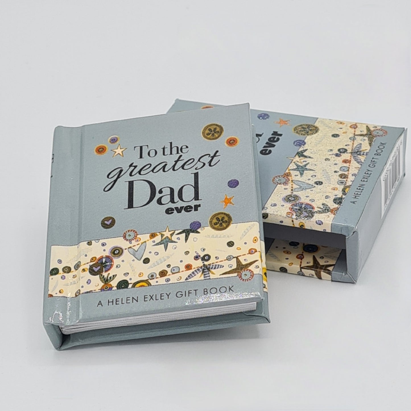 Small light blue book entitled "To the greatest dad ever" is sitting half on top of the book sleeve.