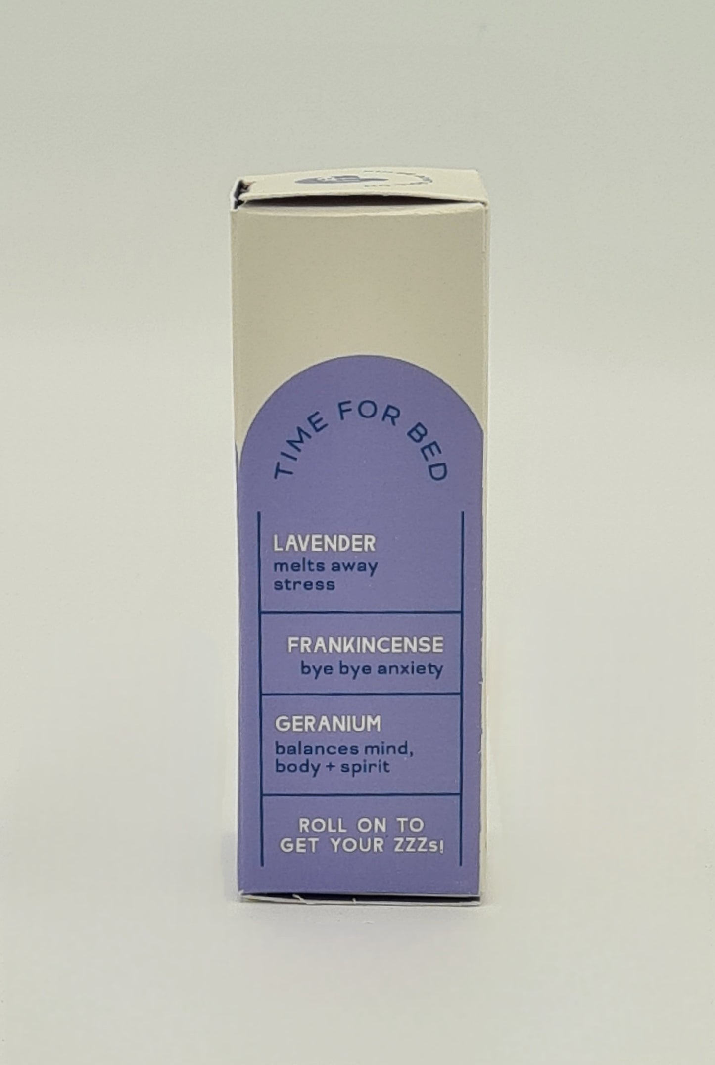 Side view of box with lilac label for Clarity Blend aromatherapy Pulse Point Roll On detailing ingredients - Lavender which melts away stress; Frankincense for bye bye to anxiety; Geranium which balances mind, body and spirit. Tagline reads "Roll on to get your ZZZs".