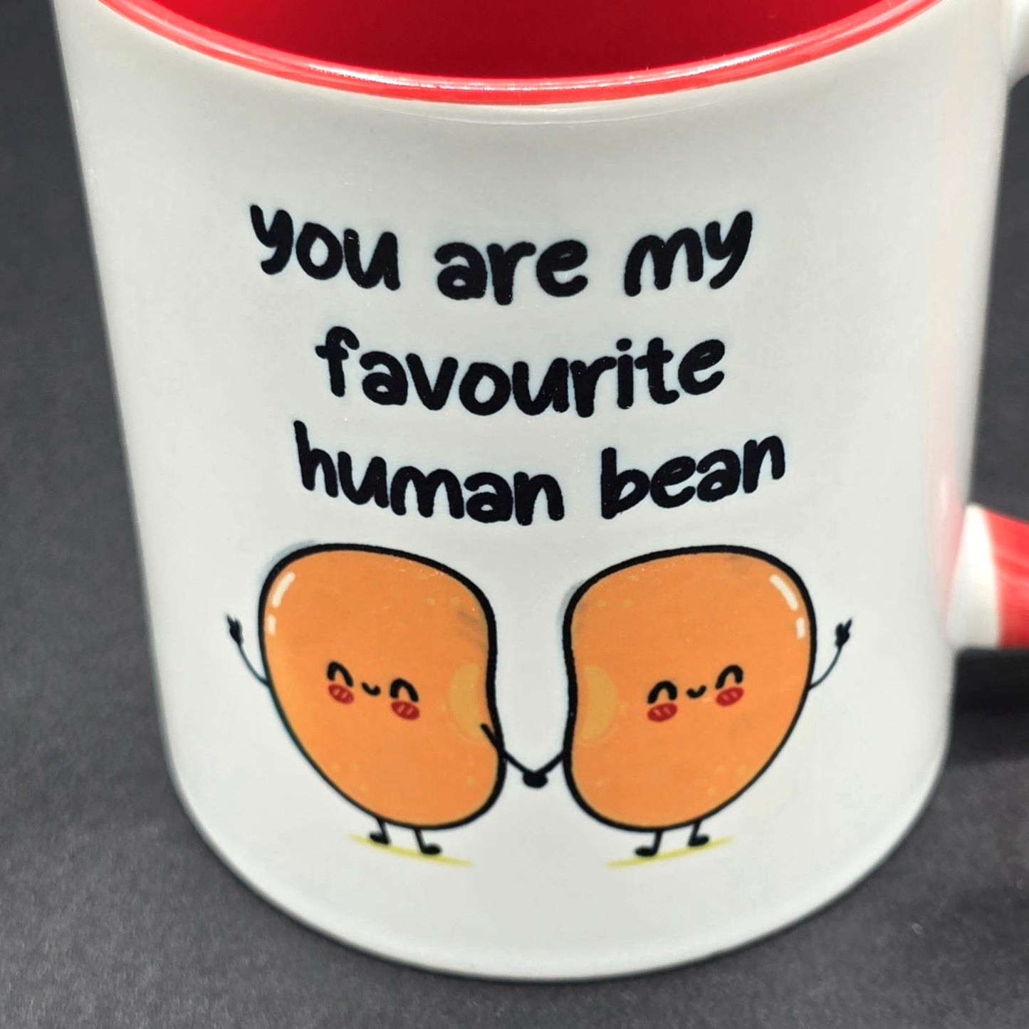 Close up image of mug with text "You are my favourite human bean" and an illustration of two beans holding hands.