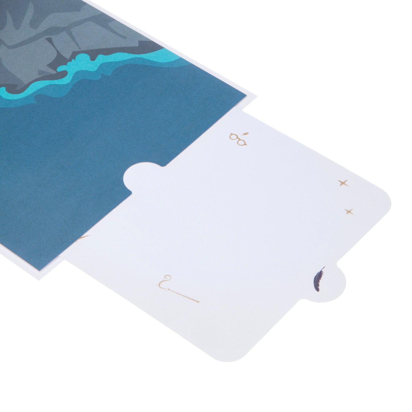 Inside of the Hogwarts Castle pop up card showing part of the right hand page. The page is blue in colour and the slide out blank notecard has been pulled out of its slot to illustrate the blank note card upon which you can write your own message. The top left hand of the notecard features an illustration of Harry Potter's glasses while the bottom right features an illustration of a wand.