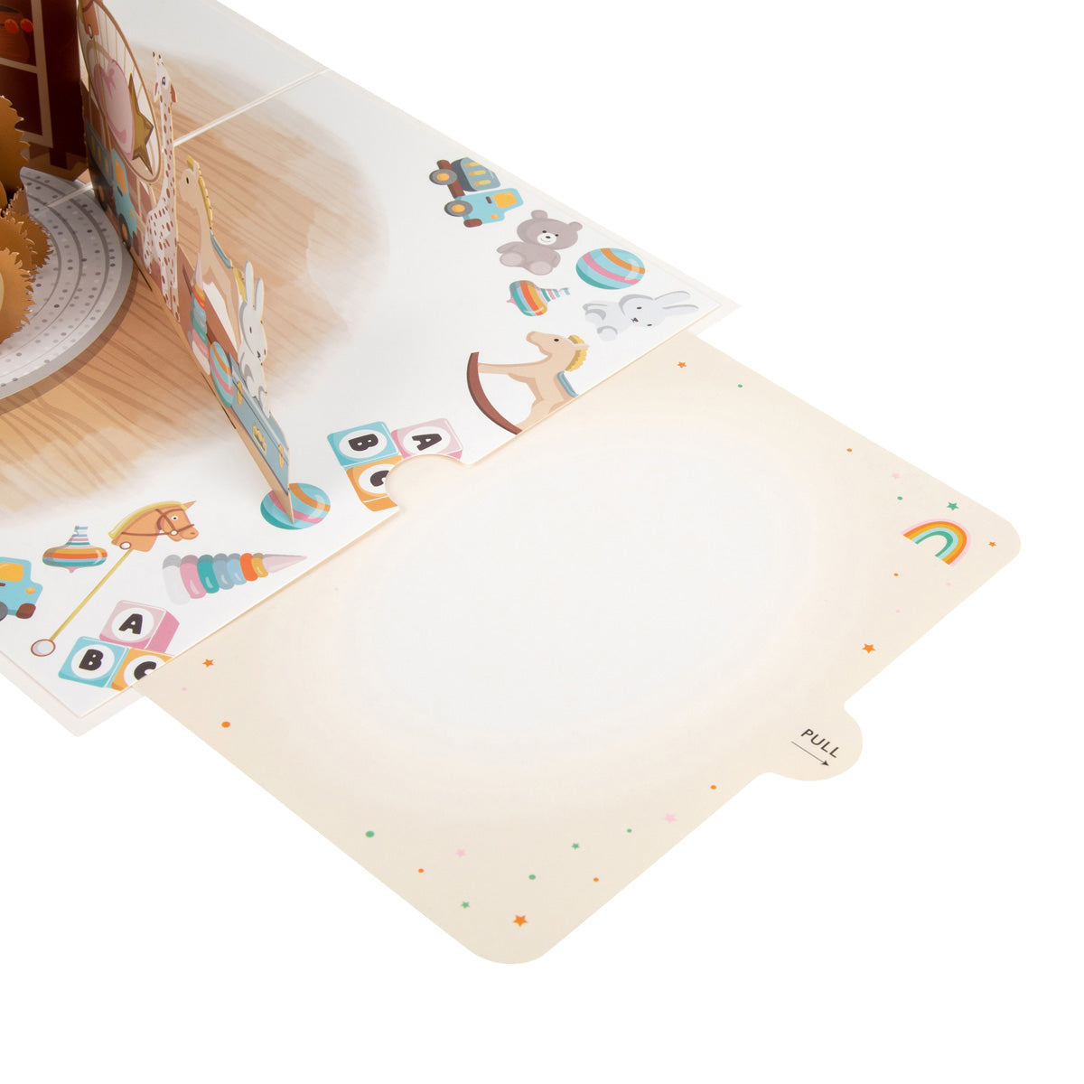 Inside of the New Baby Bear pop up card - there are illustrations of various toys on the right hand edge of the page and the slide out blank note card has been pulled out of its slot to show the blank card upon which you can write your own message.