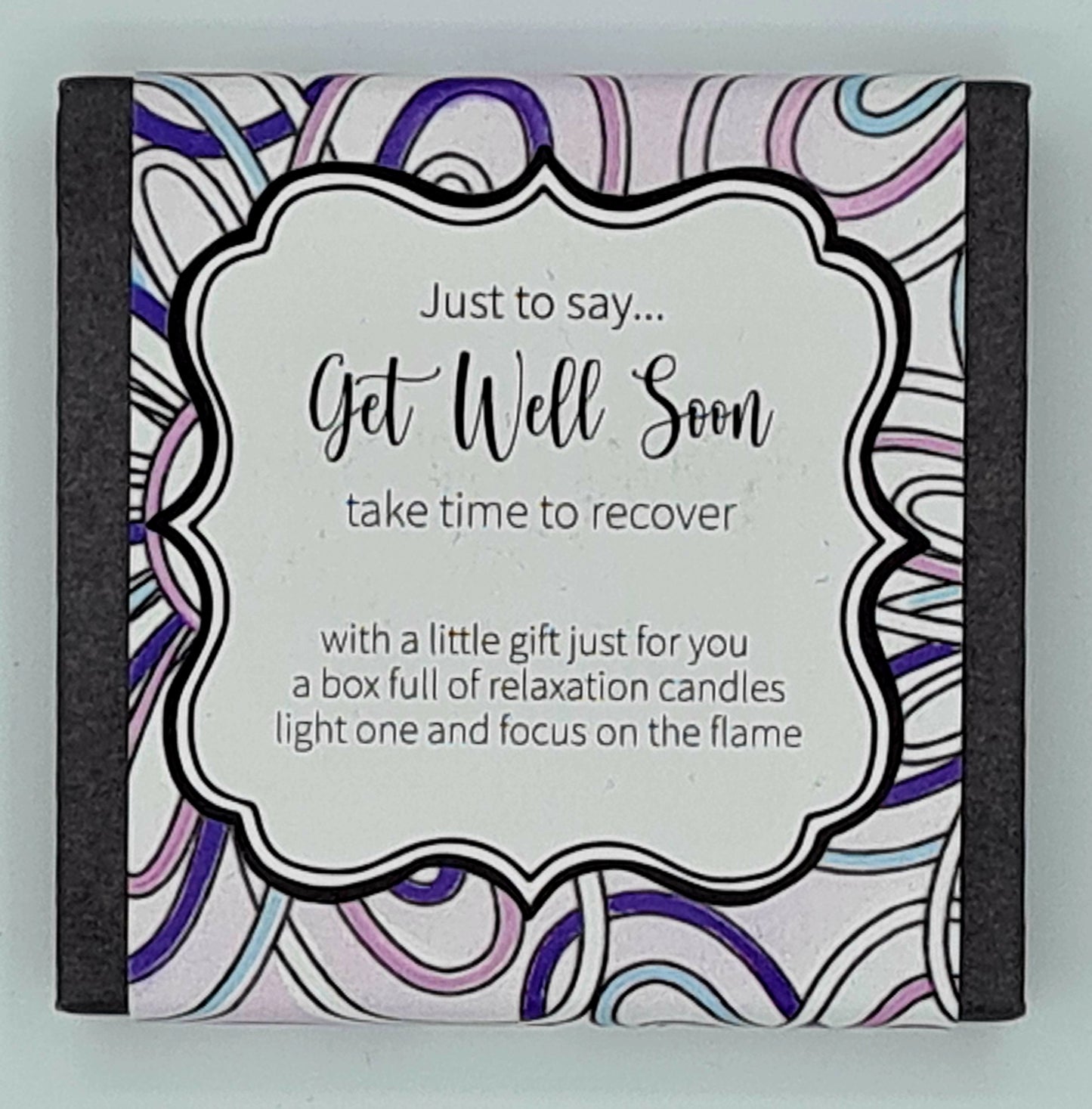 Small square black box with a coloured swirly label and a text box saying "Just to say...Get Well Soon, take time to recover...with a little gift just for you, a box full of relaxation candles, light one and focus on the flame".