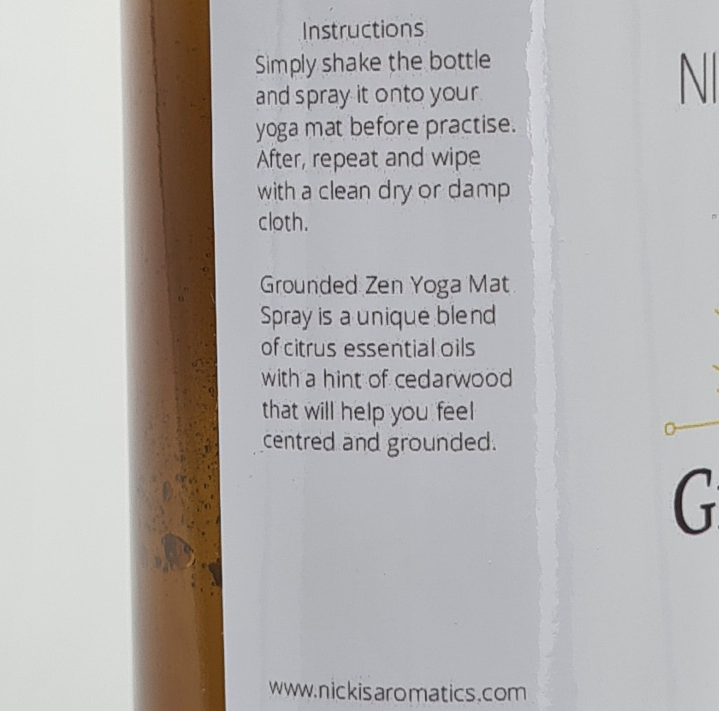 Close up of the side of the label for Grounded Zen Yoga Mat Spray. The text says:
"Instructions: Simply shake the bottle and spray it onto your yoga mat before practise. After, repeat and wipe with a clean dry or damp cloth.
Grounded Zen Yoga Mat Spray is a unique blend of citrus essential oils with a hint of cedarwood that will help you feel centred and grounded".