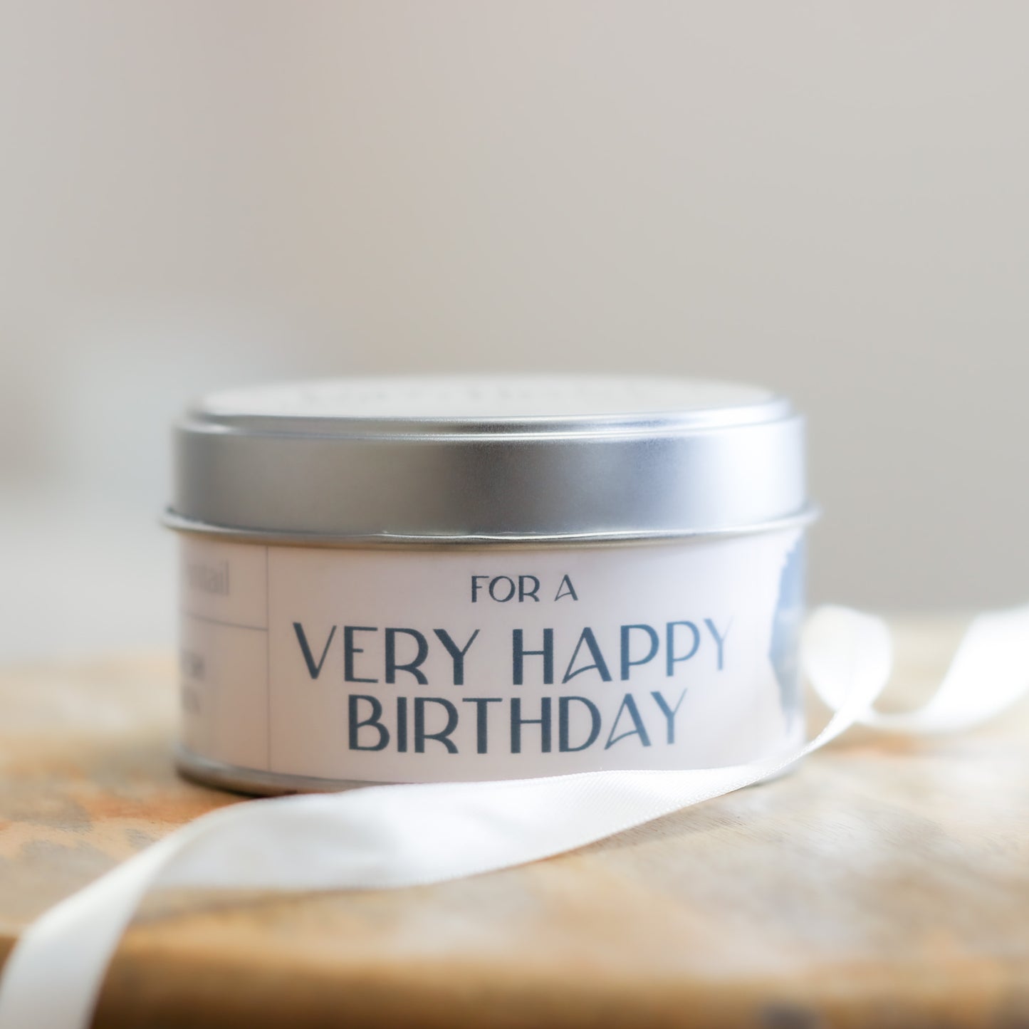 Side view of candle tin containing the wording "For a Very Happy Birthday".