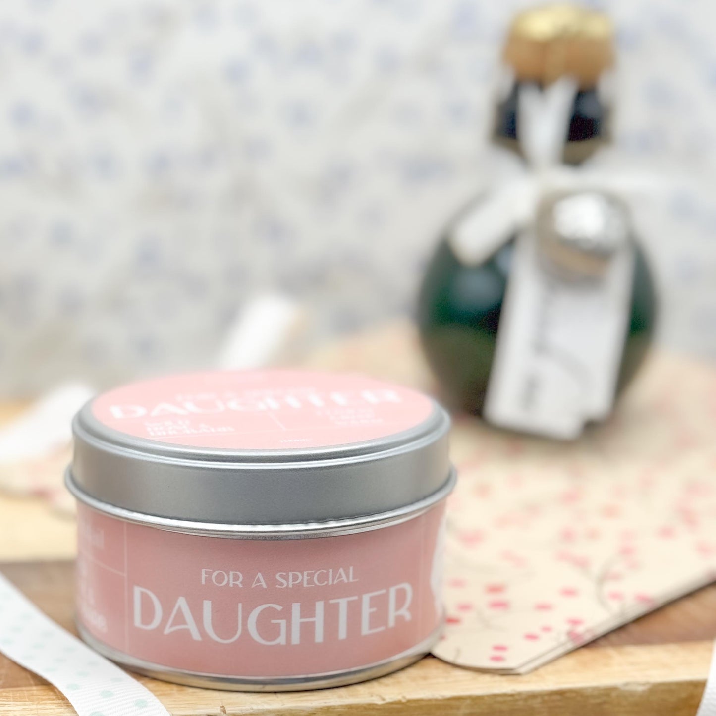 Side view of candle tin with pink label and the wording "For a Special Daughter".