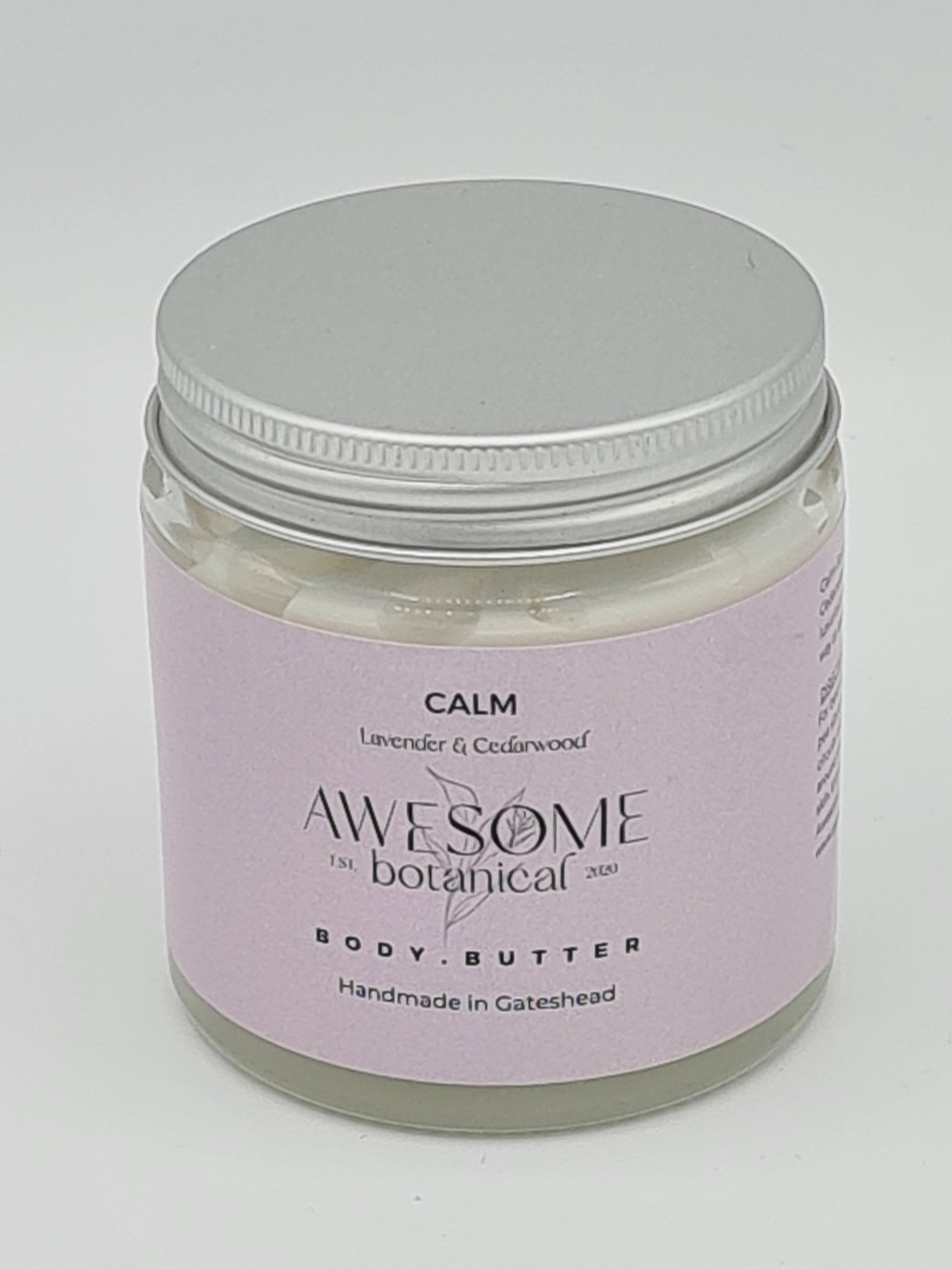 Glass jar of Body Butter with silver lid. Jar has lilac label from Awesome Botanical with the name Calm and smaller text below stating Lavender & Cedarwood