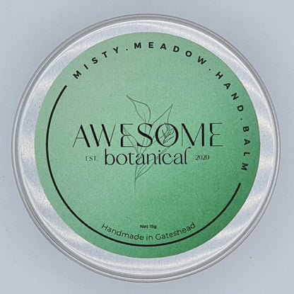 Silver tin with green label from Awesome Botanical stating Misty Meadow Hand Balm.