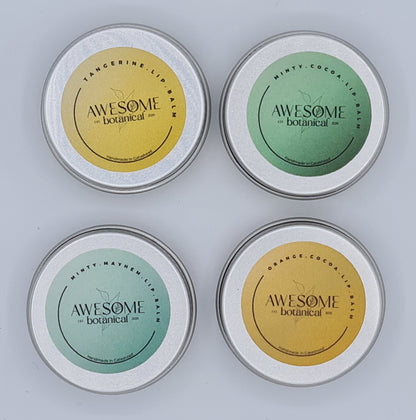 Image shows four small silver tins of lip balm from Awesome Botanical. Going clockwise from top left, the tins have a light orange label stating "Tangerine Lip Balm", green label stating "Minty Cocoa Lip Balm", orange label stating "Orange Cocoa Lip Balm" and light green label stating "Minty Mayhem Lip Balm".