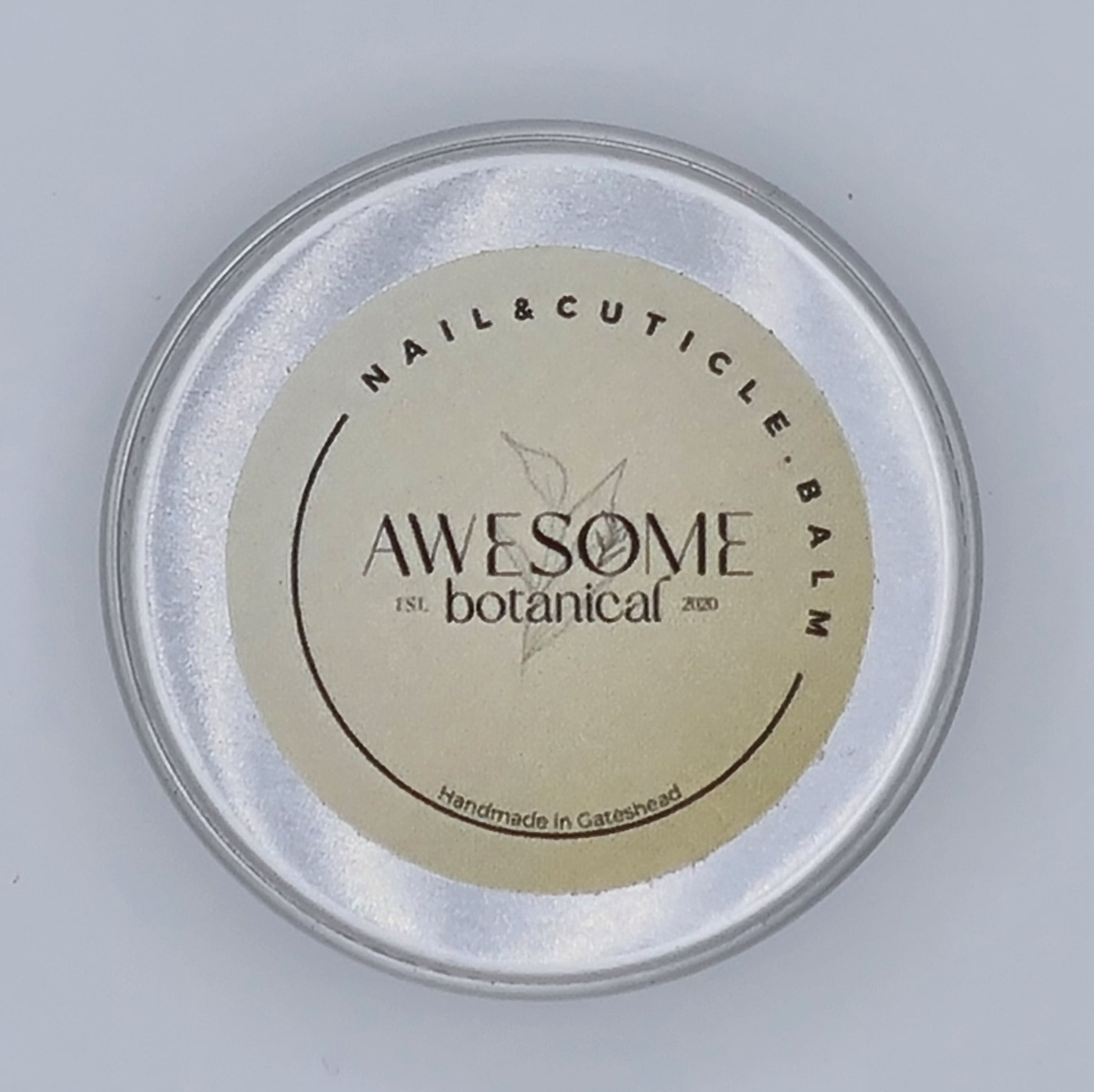 Silver tin with cream label from Awesome Botanical stating Nail & Cuticle Balm