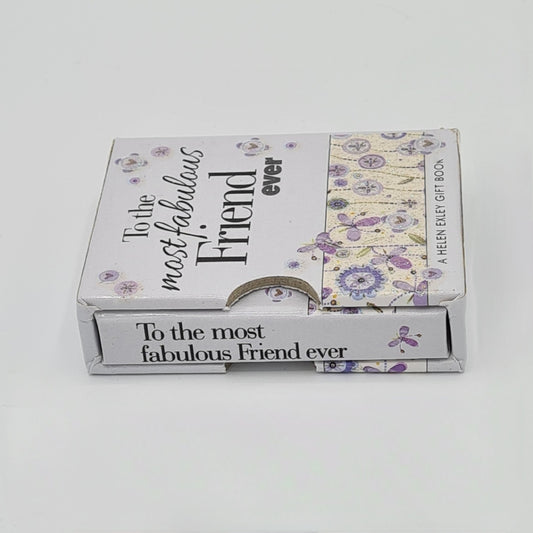 Light grey coloured little book entitled "To the most fabulous friend ever" encased in its own grey sleeve. The title of the book is written in black text and is visible on the top of the sleeve and on the spine of the book. There are illustrations of flowers and butterflies on the bottom half of the sleeve.