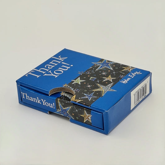 Little blue book entitled "Thank You" encased in its own blue sleeve. The title of the book is written in silver text and is visible on the top of the sleeve and on the spine of the book.