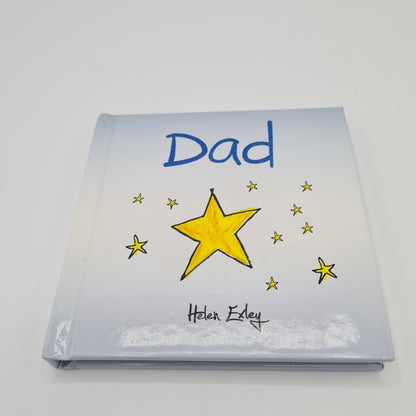 Front cover of little square book with the word "Dad" written in dark blue font at the top. The book is pale blue in colour and there is an illustration of a big yellow star in the middle with lots of small yellow stars around it.