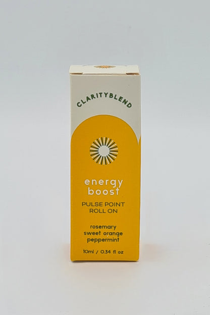 Front of box with yellow label containing Clarity Blend aromatherapy Energy Boost Pulse Point Roll On