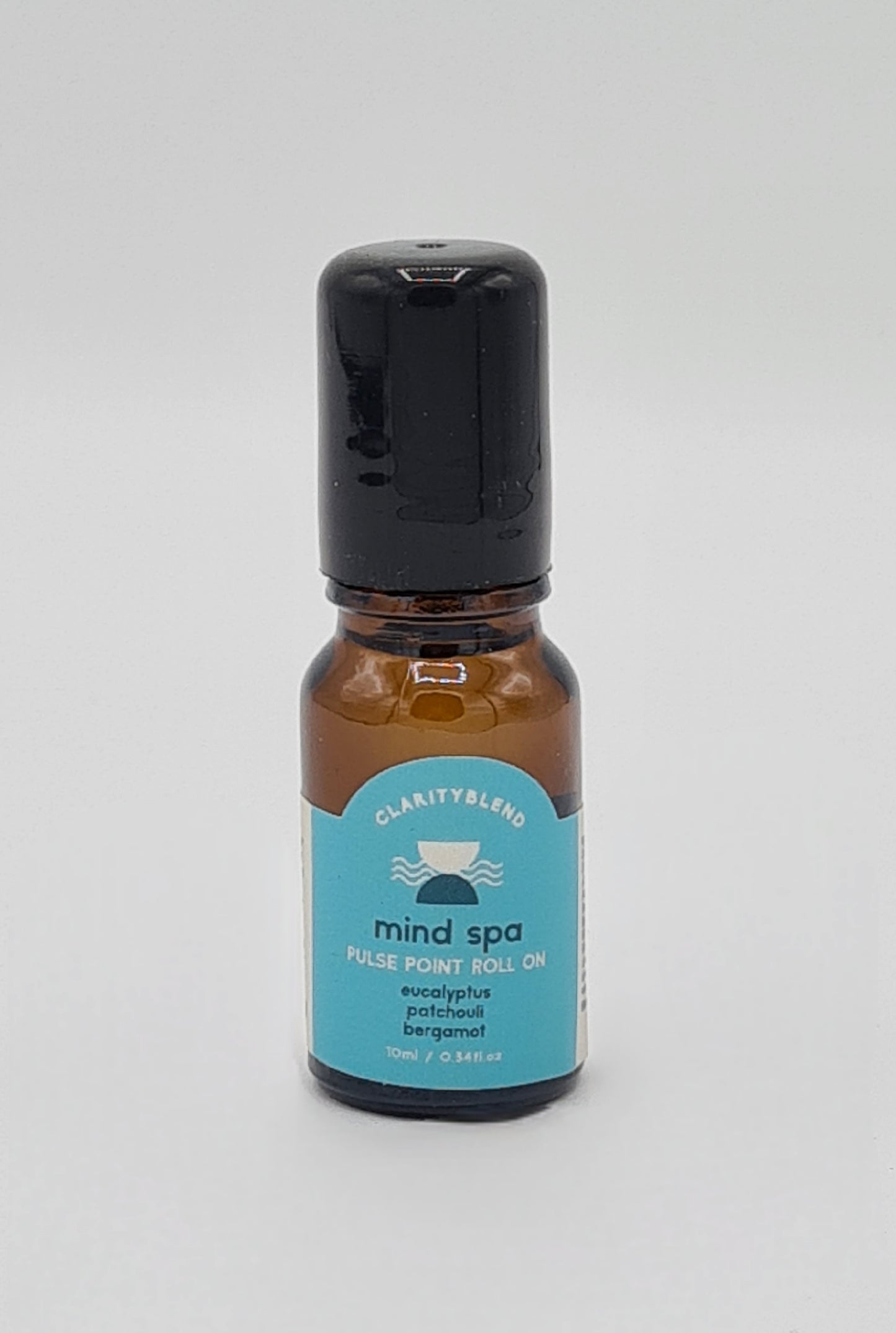 Small brown glass bottle with light blue label saying Clarity Blend Mind Spa Pulse Point Roll On