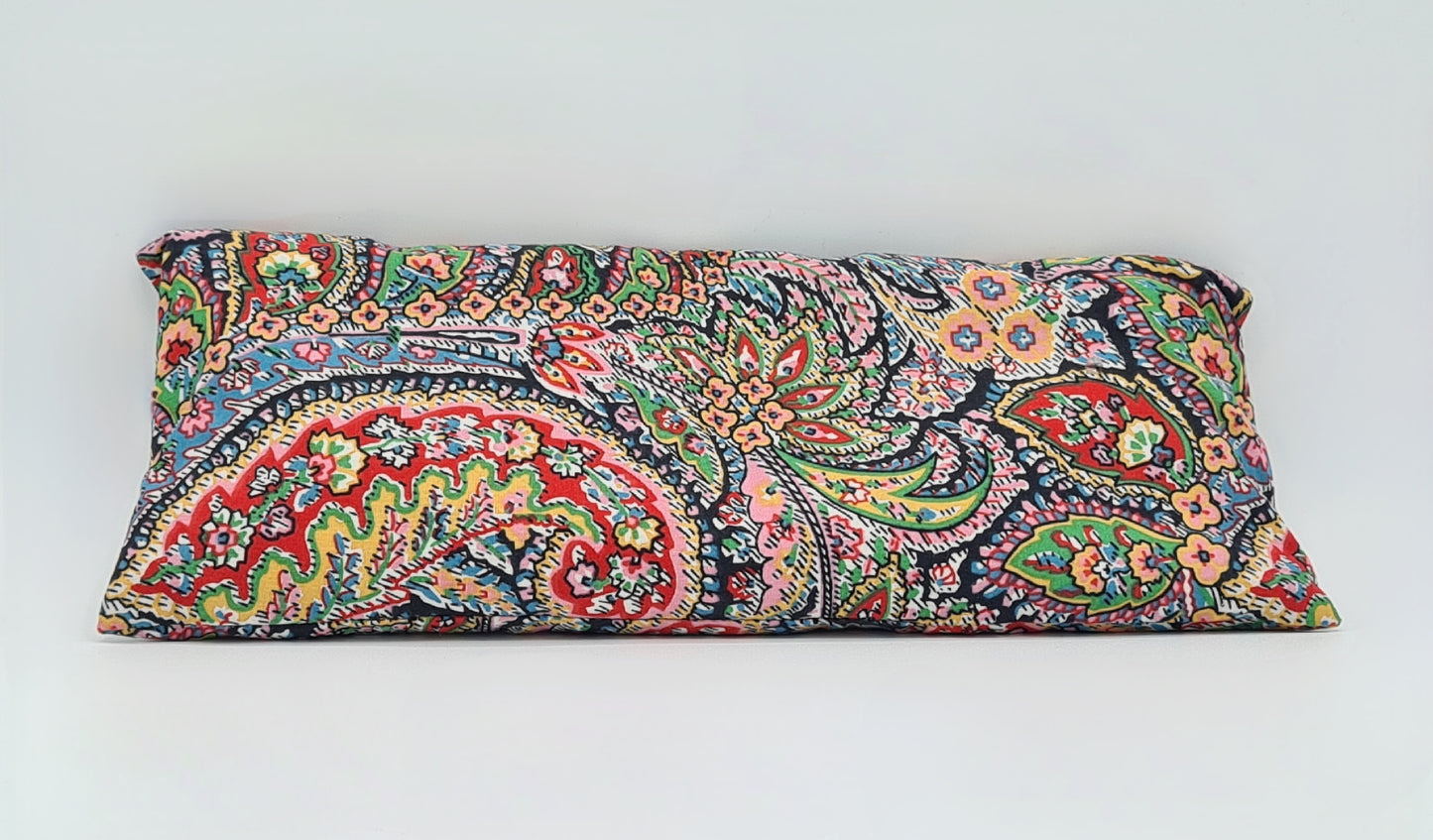 Rectangle shaped aromatherapy eye pillow in a brightly coloured paisley pattern design.