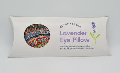 White box containing Clarity Blend Lavender Eye Pillow, described as "Relaxing Pima cotton eye pillow filled with dried lavender and flaxseed". There is a round window in the box through which you can see a brightly coloured paisley pattern.