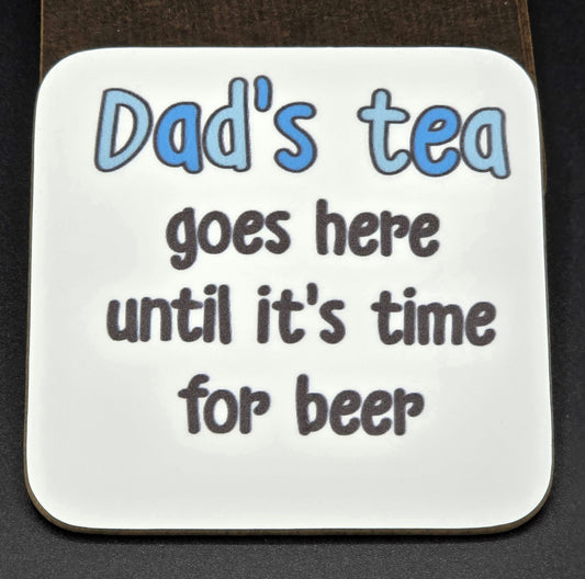 White coaster with the wording "Dad's tea goes here until it's time for beer".