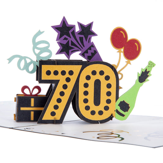 Pop up birthday card with gold number seventy with black dots. The numbers are surrounded by streamers, balloons, a champagne bottle and a wrapped gift.