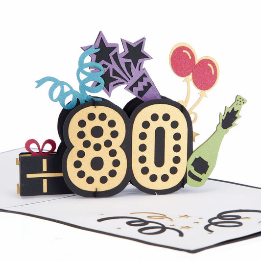 Pop up 80th birthday card with a gold number eighty with black dots. The numbers are surrounded by blue and purple streamers, red balloons, a champagne bottle and a wrapped gift.