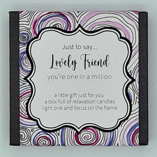 Small black square box with a label showing pink and purple swirls and a white text box saying "Just to say...Lovely Friend, you're one in a million. A little gift just for you, a box full of relaxation candles, light one and focus on the flame". 