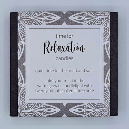 Small black square box with grey patterned label with a white text box saying "Time for Relaxation candles. Quiet time for the mind and soul. Calm your mind in the warm glow of candlelight with twenty minutes of guilt free time".