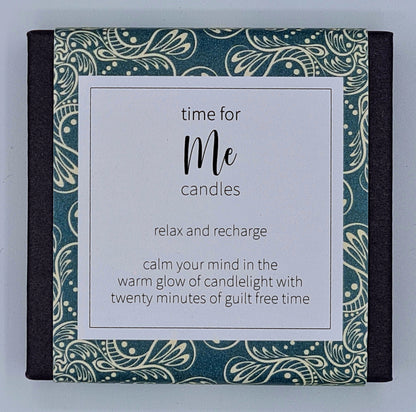 Small black square box with dark green patterned label with white text box saying "Time for Me candles. Relax and recharge. Calm your mind in the warm glow of candlelight with twenty minutes of guilt free time". 
