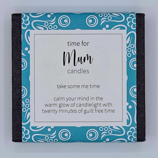 Small black square box with a blue patterned label and white text box saying "Time for Mum candles. Take some me time. Calm your mind in the warm glow of candlelight with twenty minutes of guilt free time". 