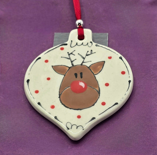 Decorative ornament with a reindeer design on a purple background