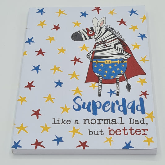 A6 Notebook, the front cover of which has red, yellow and blue stars and a drawing of a zebra dressed as a superhero with red eye mask, blue starry pants and a red cape. Text on the cover reads "Superdad, like a normal dad but better".