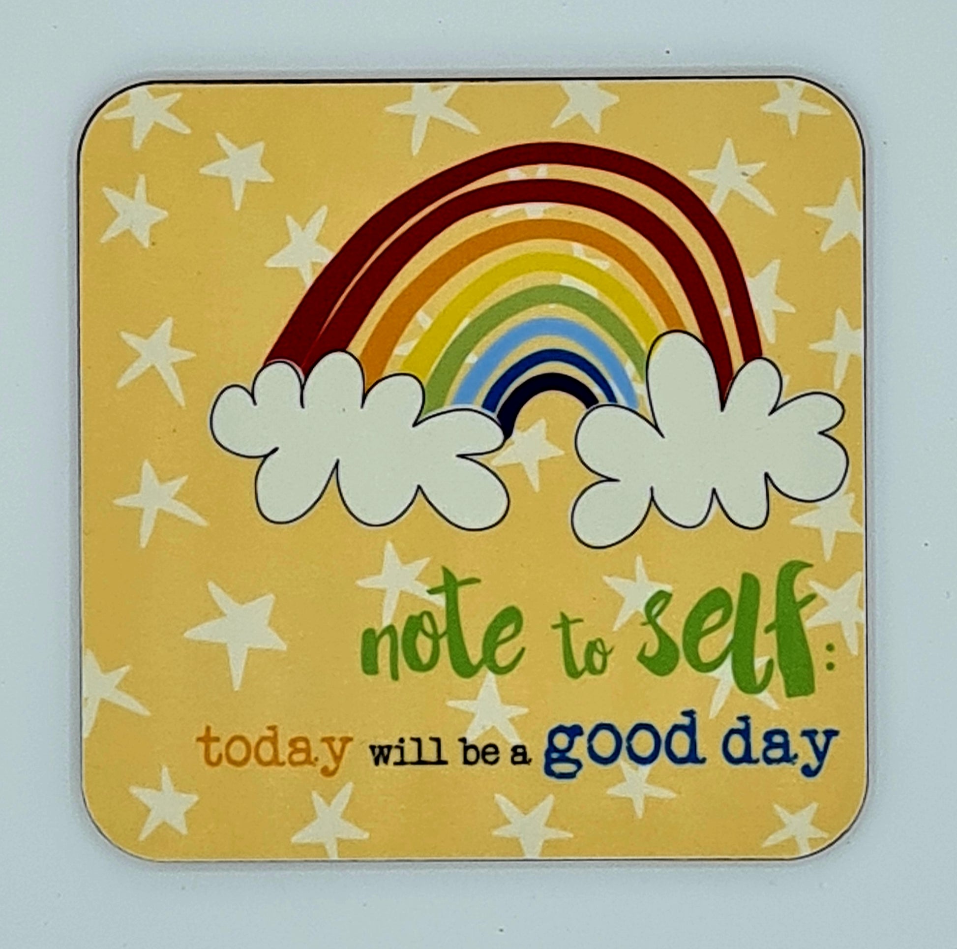 Yellow coaster with white stars and a drawing of a rainbow, The slogan reads "Note to self: today will be a good day". 