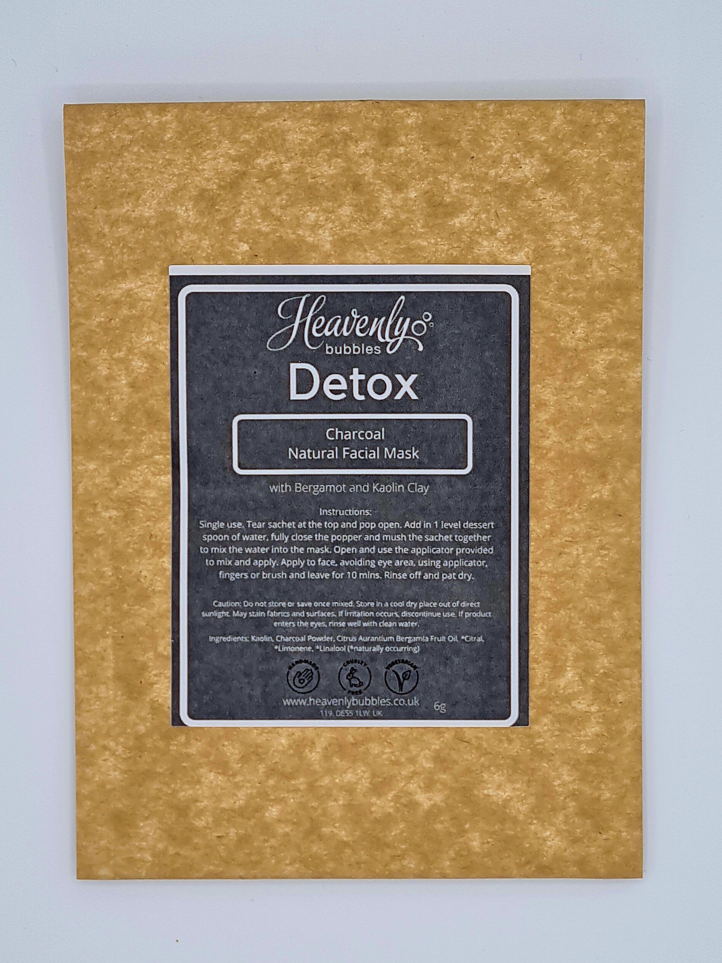 Brown kraft pouch with black label from Heavenly Bubbles stating Detox, Charcoal Natural Facial Mask with Bergamot and Kaolin Clay.