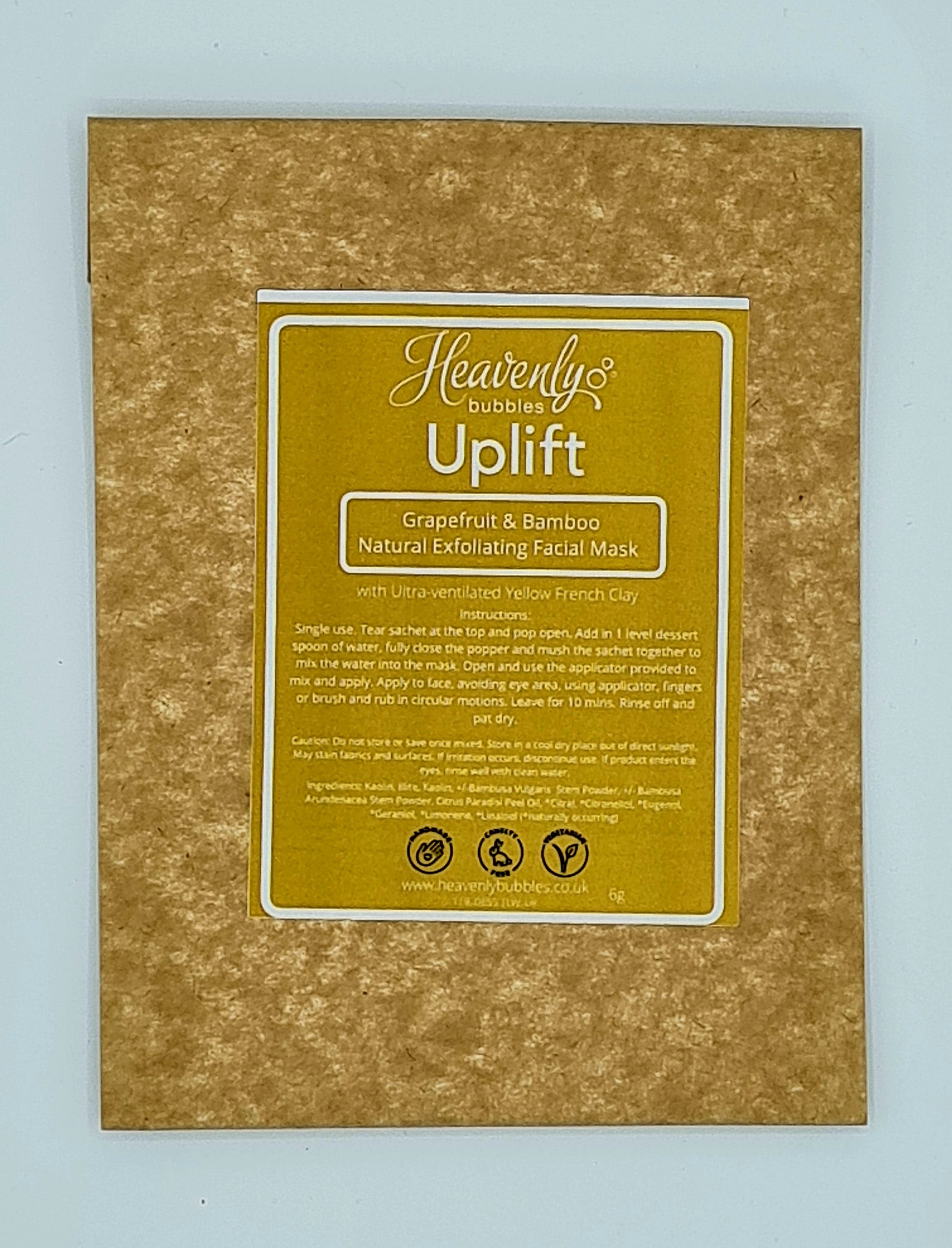 Brown kraft pouch with yellow label from Heavenly Bubbles stating Uplift, Grapefruit & Bamboo Natural Exfoliating Facial Mask with Ultra-ventilated Yellow French Clay. 