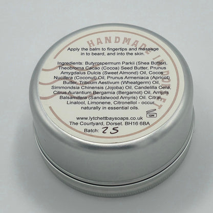 Back or bottom side of tin of Bearded Wonder Beard Balm with light coloured label. Text says "Apply the balm to fingertips and massage in to beard, and into the skin". It then lists the ingredients. 