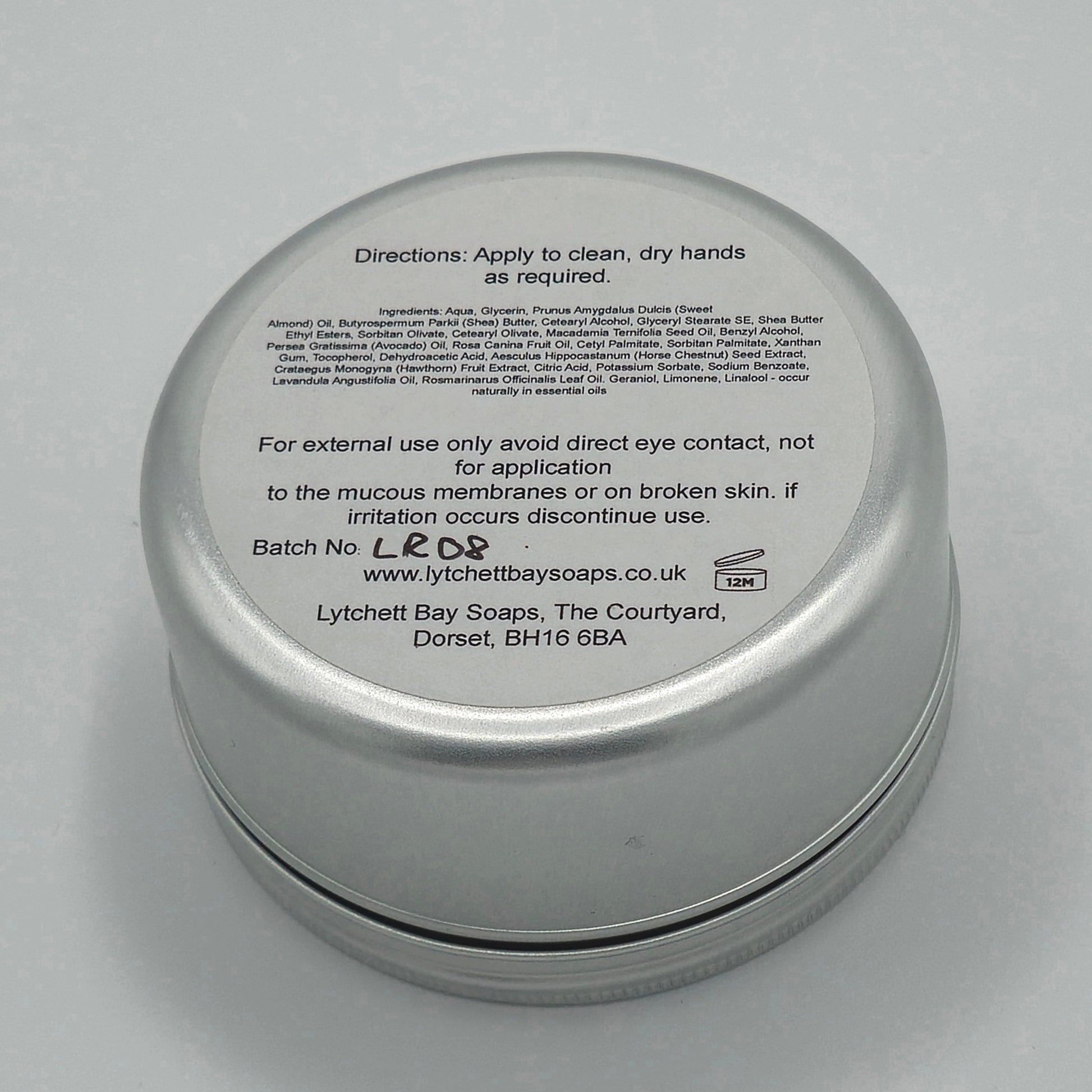 The back or bottom side of the silver tin containing Gardeners Hand Cream. The text at the top says "Directions: Apply to clean, dry hands as required."
There is smaller text with the ingredients listed and then larger text again saying "For external use only, avoid direct eye contact, not for application to the mucous membranes or on broken skin, if irritation occurs discontinue use".