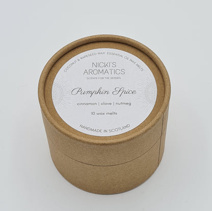 Round kraft cardboard box with a white label on the top with the text "Coconut & Rapeseed Wax Essential Oil Wax Melts" along the top. Below this is the logo for "Nicki's Aromatics" and the strapline "Scents for the Senses". In the middle of the label is the name "Pumpkin Spice" with "Cinnamon", "Clove" "Nutmeg" and "10 wax melts" typed below. At the very bottom of the label is the wording "Handmade in Scotland".