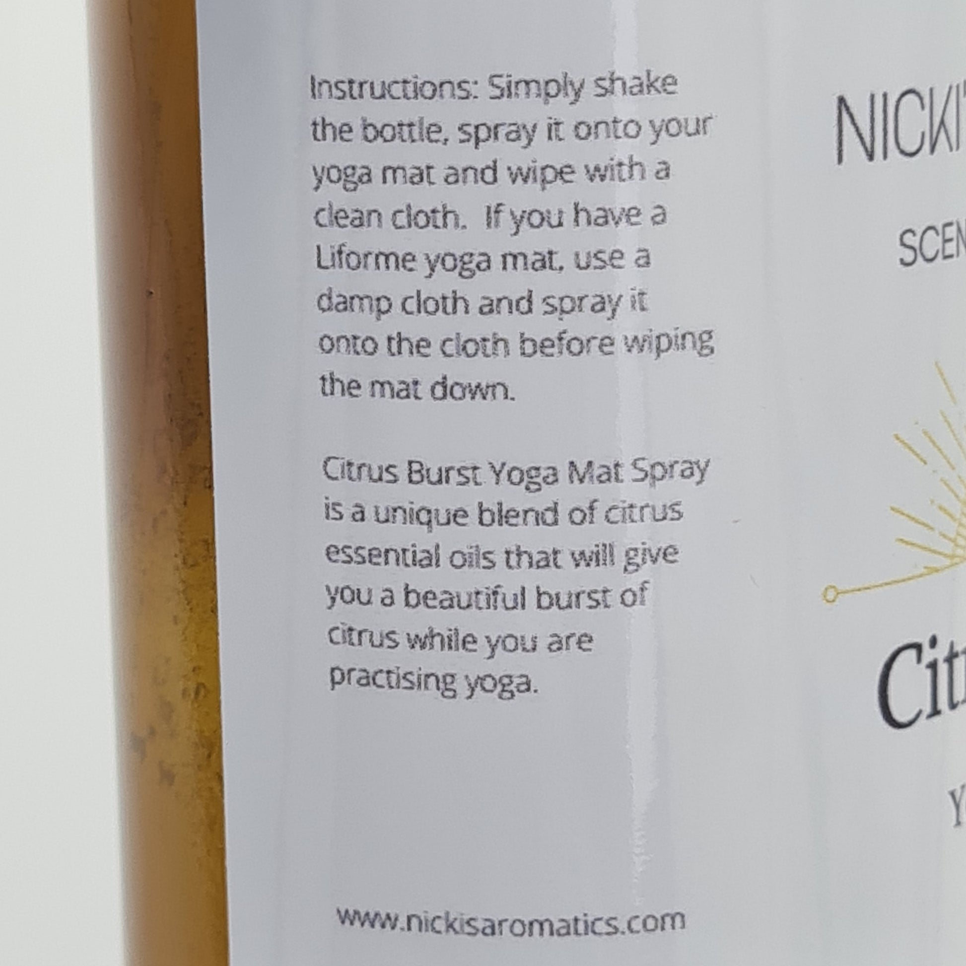 Close up of the side of the label for Citrus Burst Yoga Mat Spray. The text says:
"Instructions: Simply shake the bottle, spray it onto your yoga mat and wipe with a clean cloth. If you have a Liforme yoga mat, use a damp cloth and spray it onto the cloth before wiping the mat down.
Citrus Burst Yoga Mat Spray is a unique blend of citrus essential oils that will give you a beautiful burst of citrus while you are practising yoga".