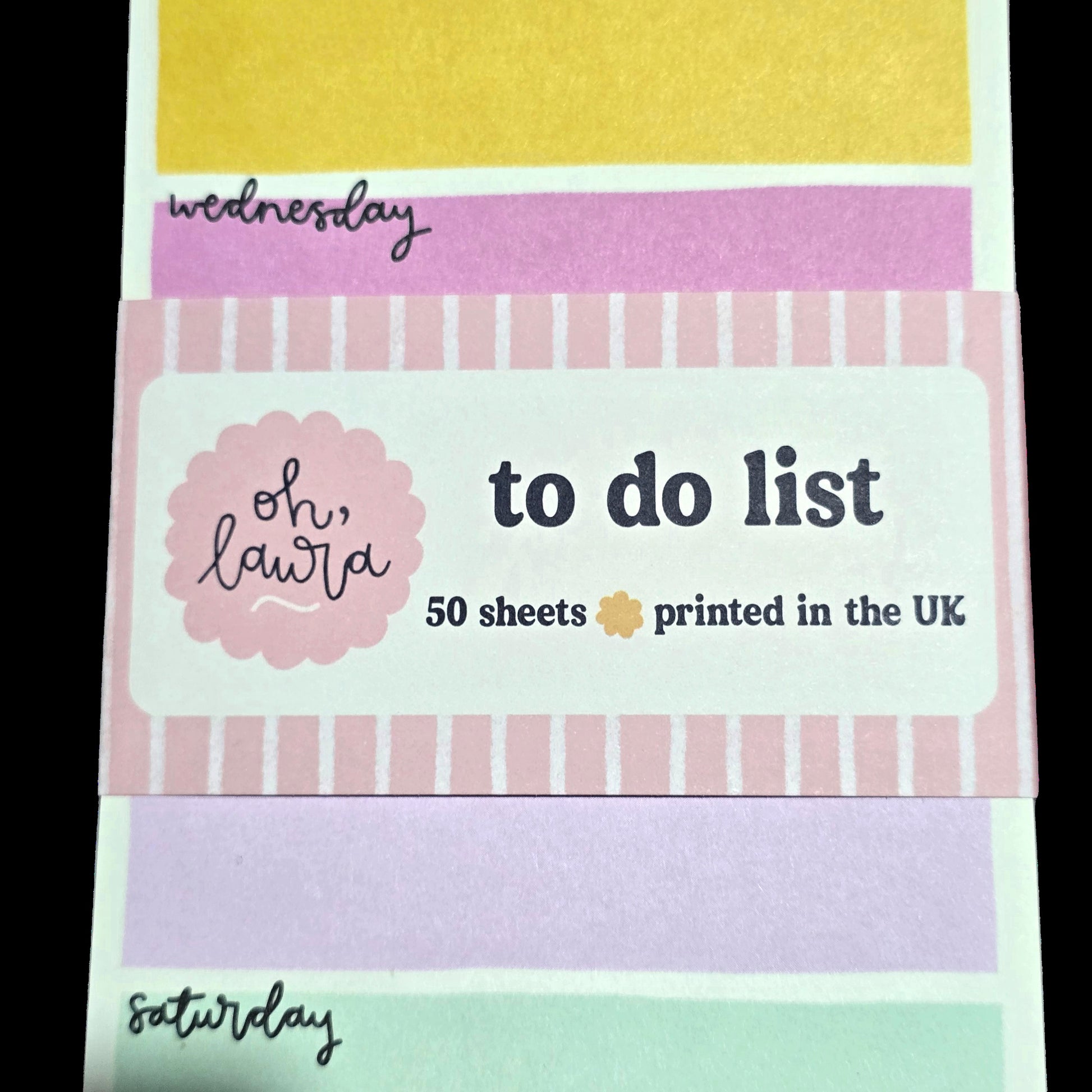 Stack of colorful 'to do list' pads with 'oh, laura' branding.