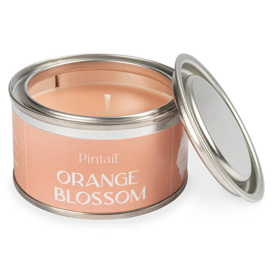 Petite paint pot candle tin from Pintail Candles. It has a pale orange label with white text. The label reads "Pintail" at the top and the fragrance "Orange Blossom" at the bottom.