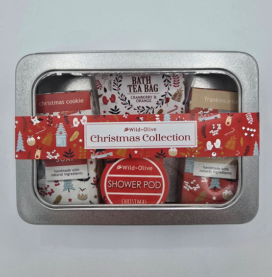 Silver gift tin containing Christmas Collection bath tea bag, shower pod and soap bars from Wild Olive